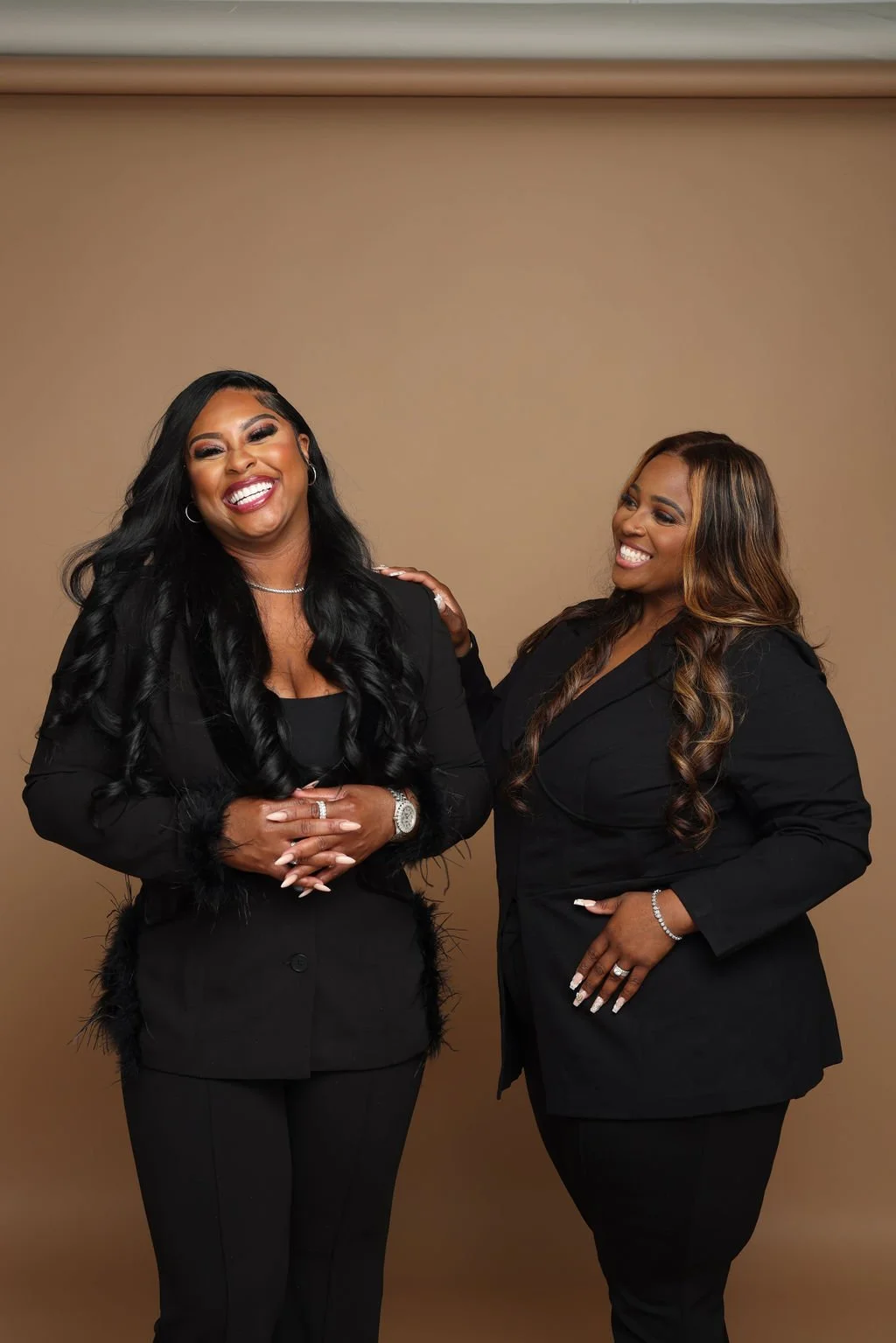 AshRoq Financial co-presidents Marredia Roquemore and Ashley Lewis laughing together